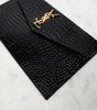 SAINT LAURENT
Uptown patent leather clutch